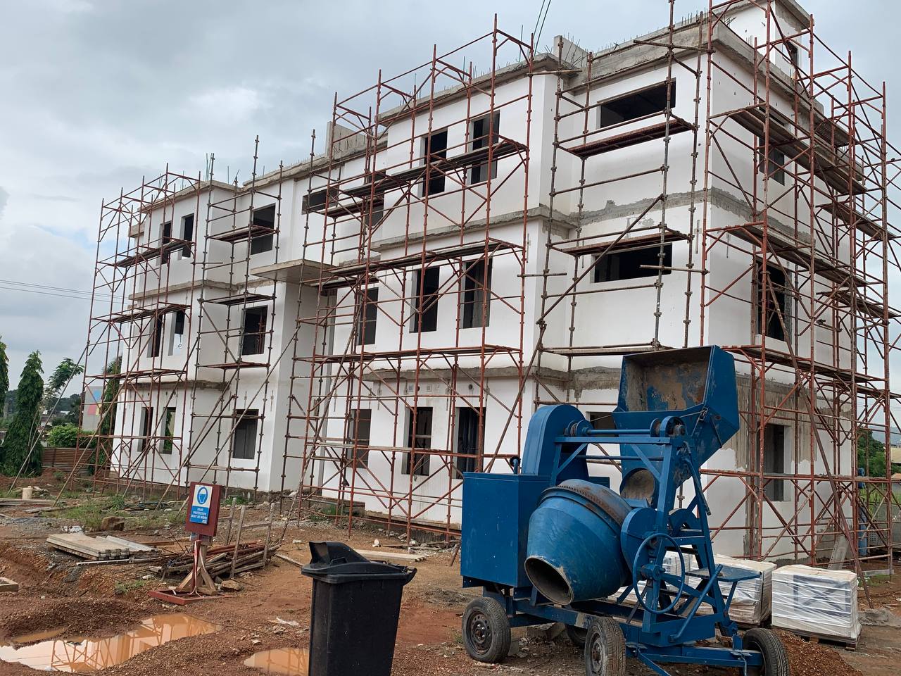 Multi-storey residential block under construction with full scaffolding