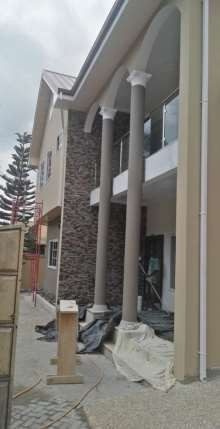House with columns and stone cladding